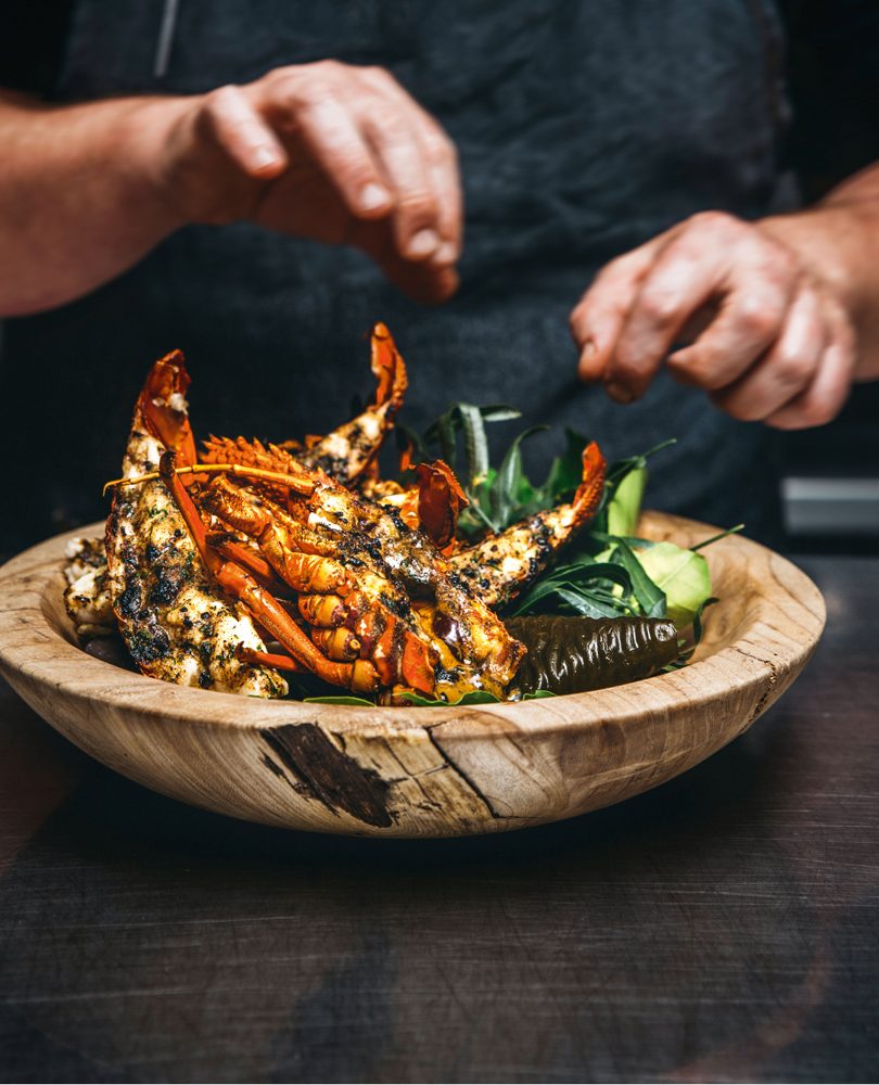 CRAYFISH GRILLED ON MARLBOROUGH SALT WITH BLACK GARLIC & WILD PEPPER BUTTER